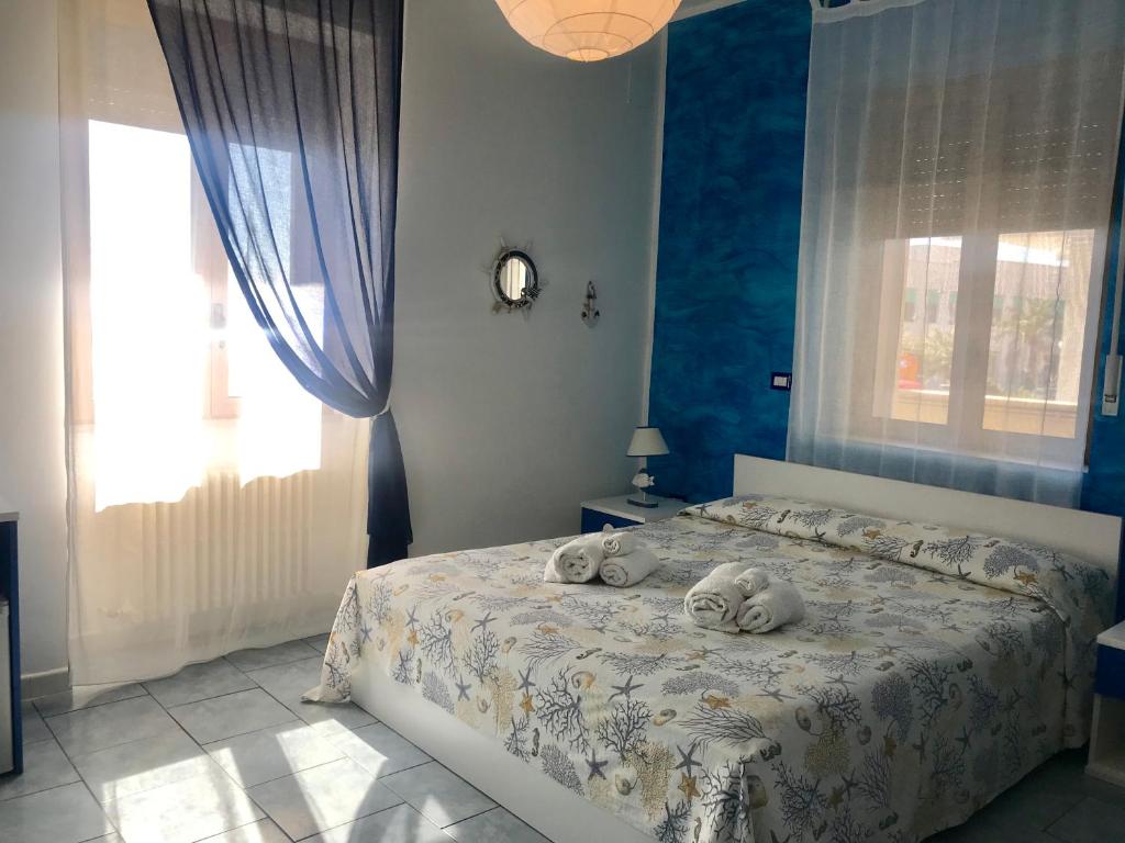 1 dormitorio con 1 cama con toallas en Divino Bed & Breackfast en Manfredonia