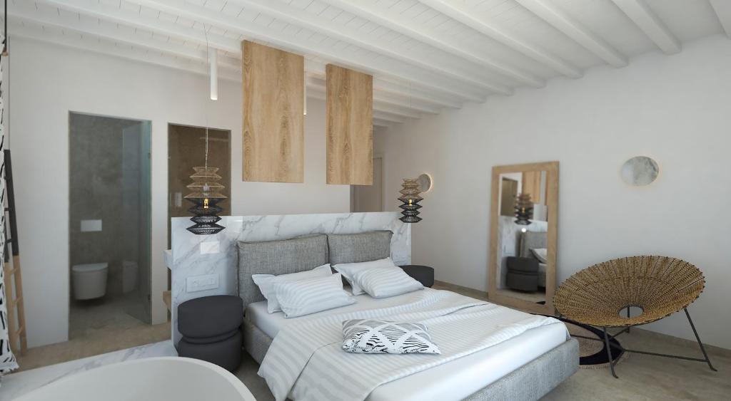 a white bedroom with a bed and a chair at Apiro Mykonos in Mýkonos City