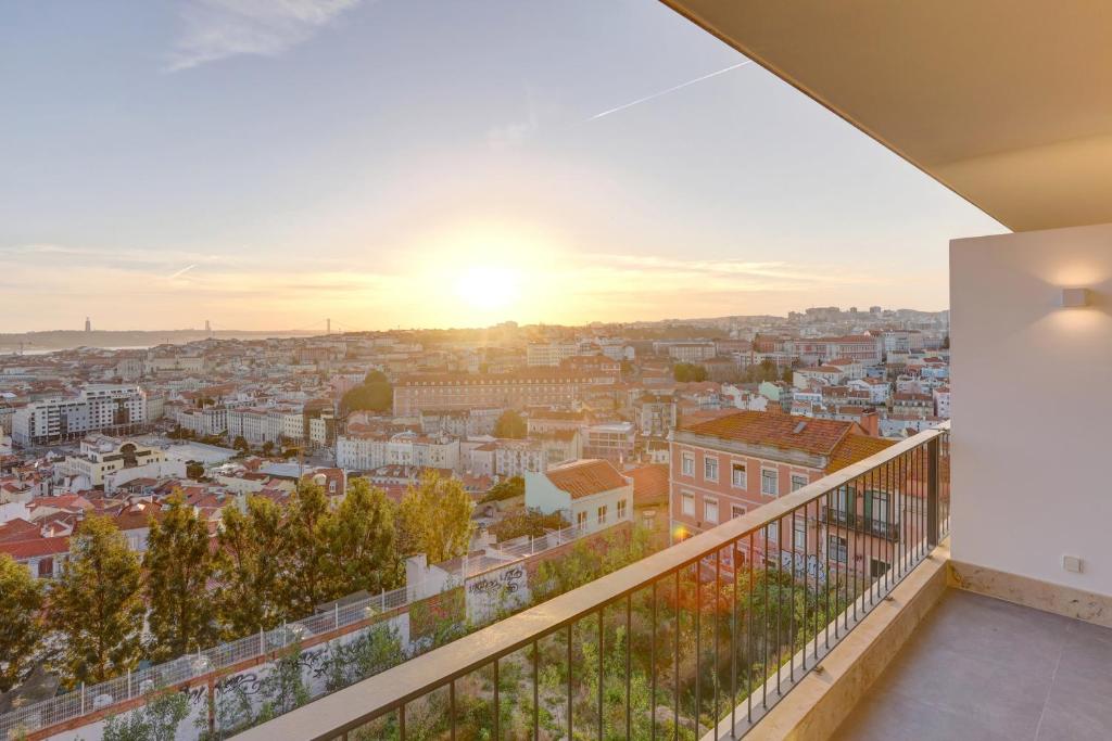 View from a modern apartment balcony in Lisbon, overlooking the city, symbolizing a prime real estate investment spurred by the city's vibrancy.