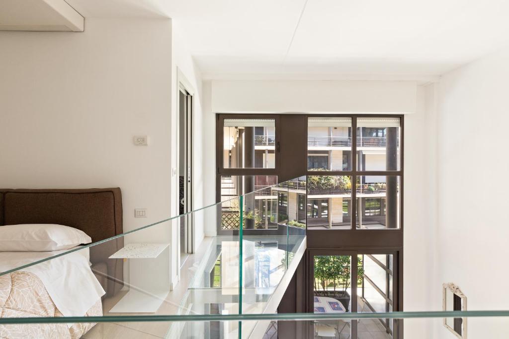 a glass staircase in a bedroom with a bed at Elegant Loft with Balcony! in Milan