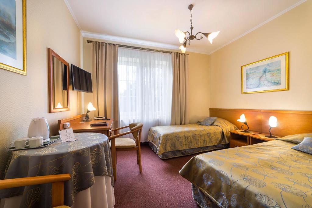 Postel nebo postele na pokoji v ubytování Lech Resort & Spa