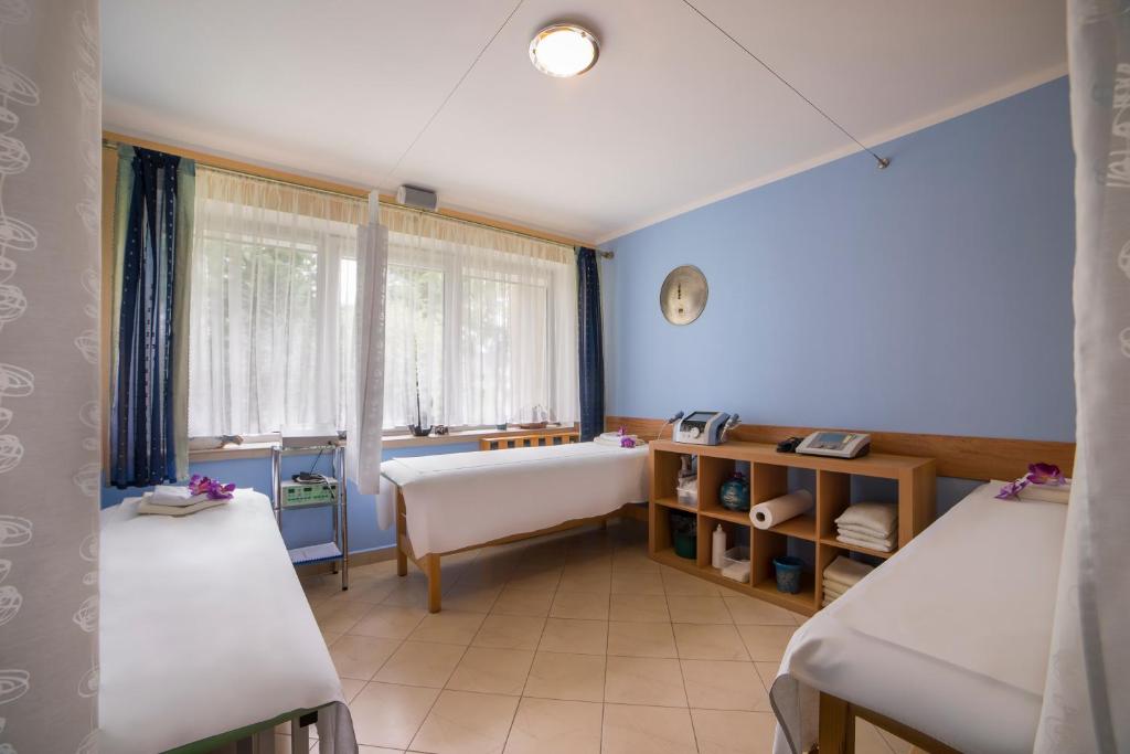 Postel nebo postele na pokoji v ubytování Lech Resort & Spa