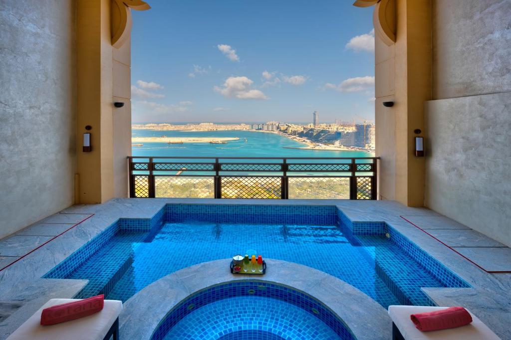 a swimming pool with a view of the ocean at Arjaan by Rotana - Dubai Media City in Dubai