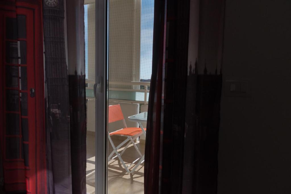 a view of a balcony with a chair and a table at Coco'S Rooms in Bari Palese