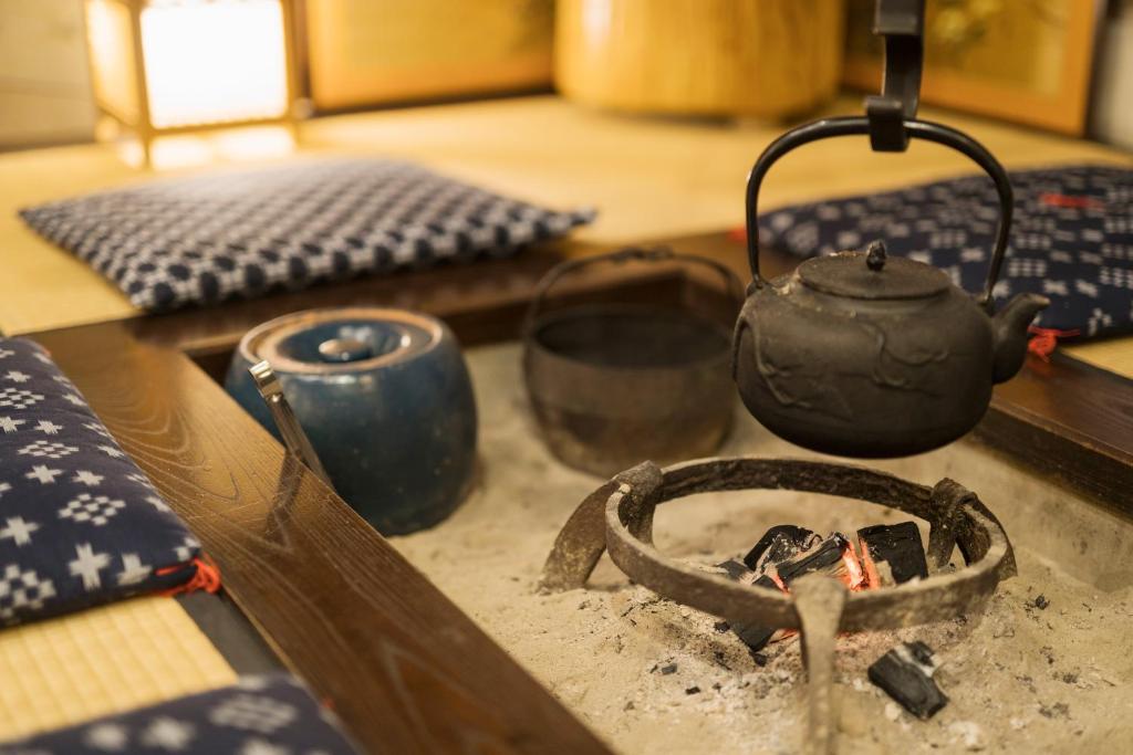 a stove with a tea pot on top of it at Ryokan Asunaro in Takayama