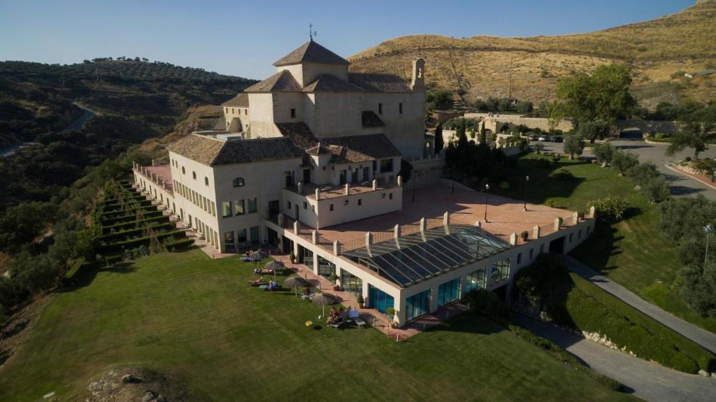 a large white building with a blue roof at DWO Convento la Magdalena in Antequera