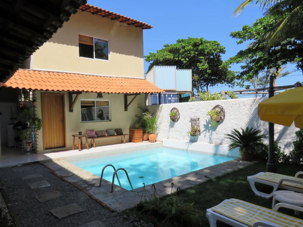 a swimming pool in front of a house at Vila Ebert in Niterói