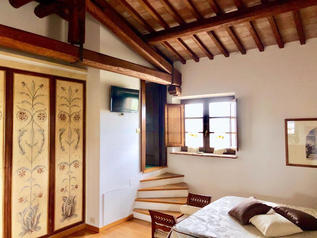 a bedroom with a bed and stairs in a room at Agriturismo Podere Pescara in Orvieto