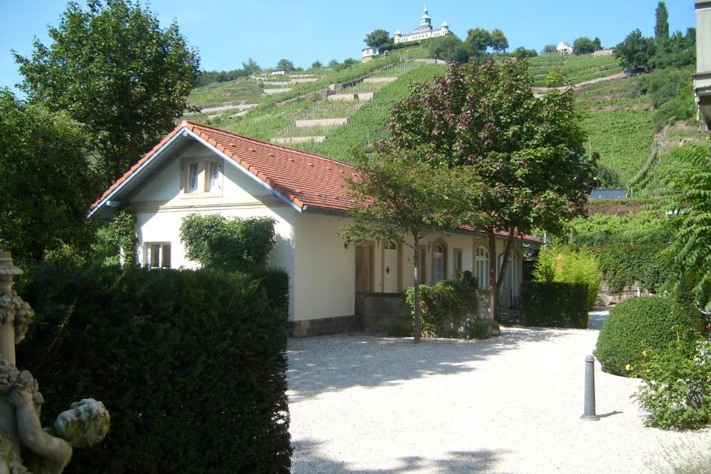 a small house with a hill in the background at Villa Jordan in Radebeul