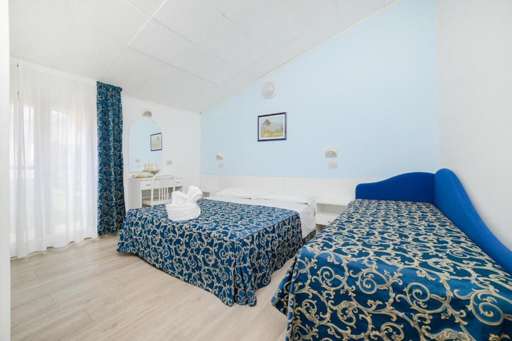 Postel nebo postele na pokoji v ubytování Hotel Vasco