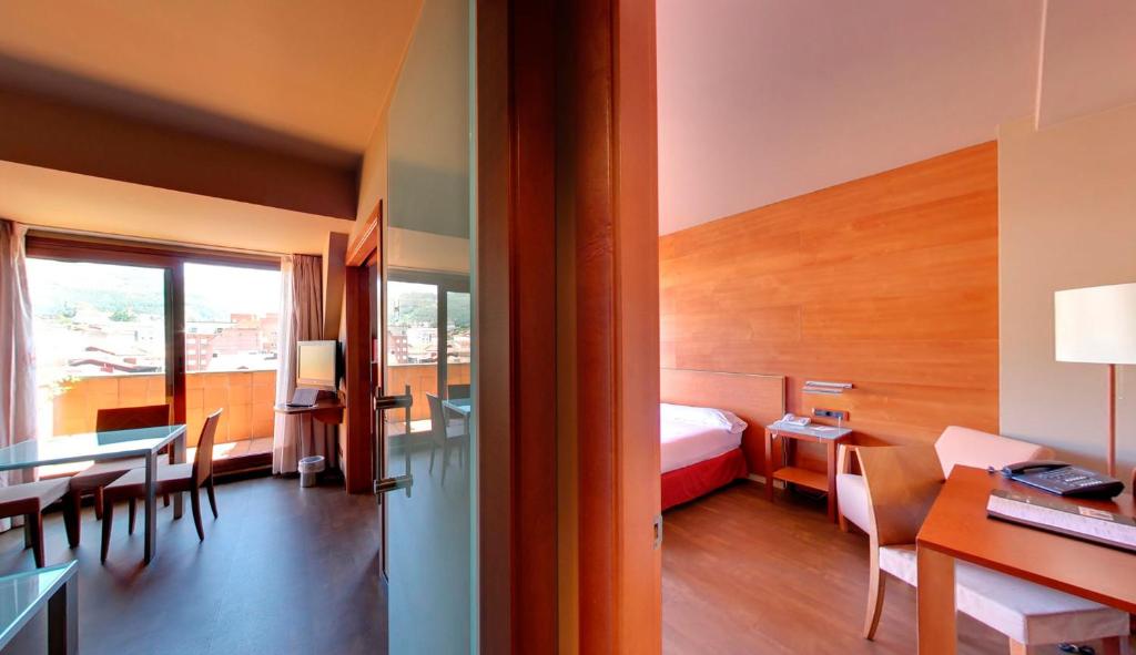 A bed or beds in a room at Silken Monumental Naranco