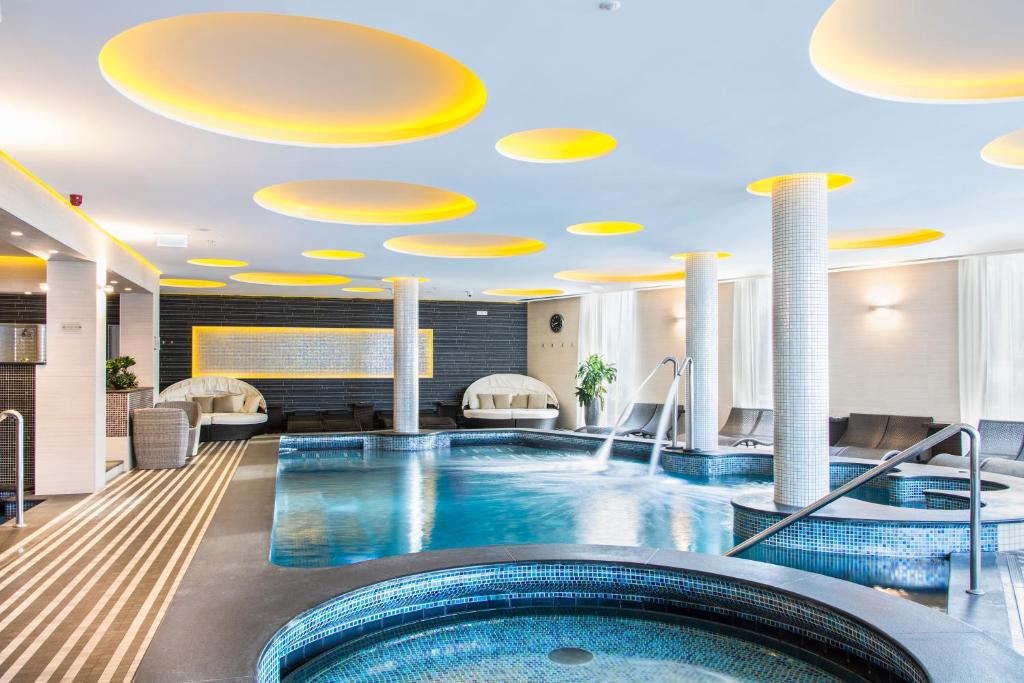 a large swimming pool in a hotel room at Aura Hotel Adults Only in Balatonfüred