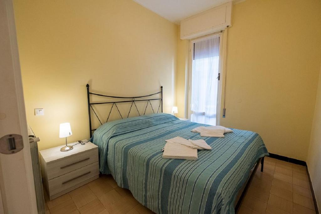 a bedroom with a bed with two towels on it at Mae's Apartment in Monterosso al Mare