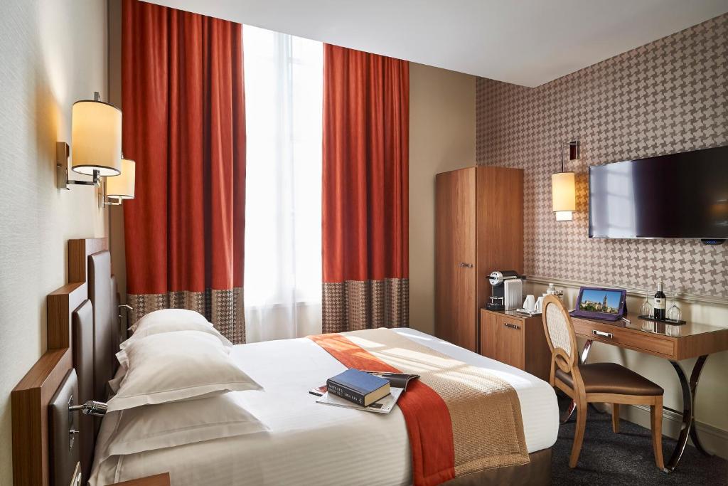 a hotel room with a bed and a desk at Best Western Premier HBEO Bordeaux Centre in Bordeaux