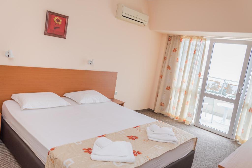 Postel nebo postele na pokoji v ubytování Hotel Eva