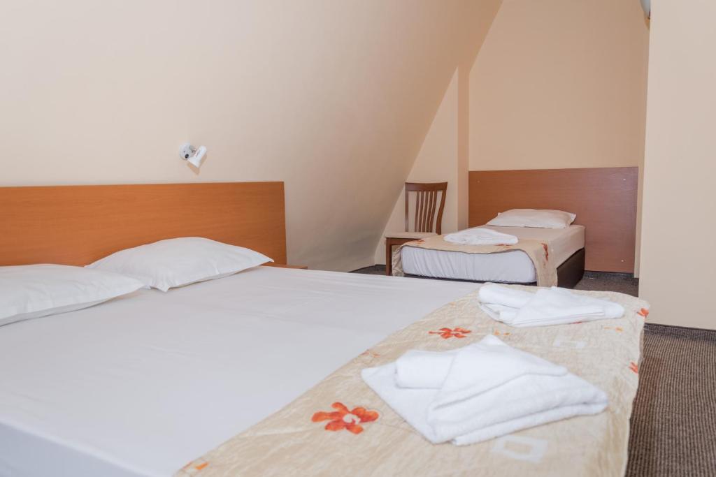 Postel nebo postele na pokoji v ubytování Hotel Eva