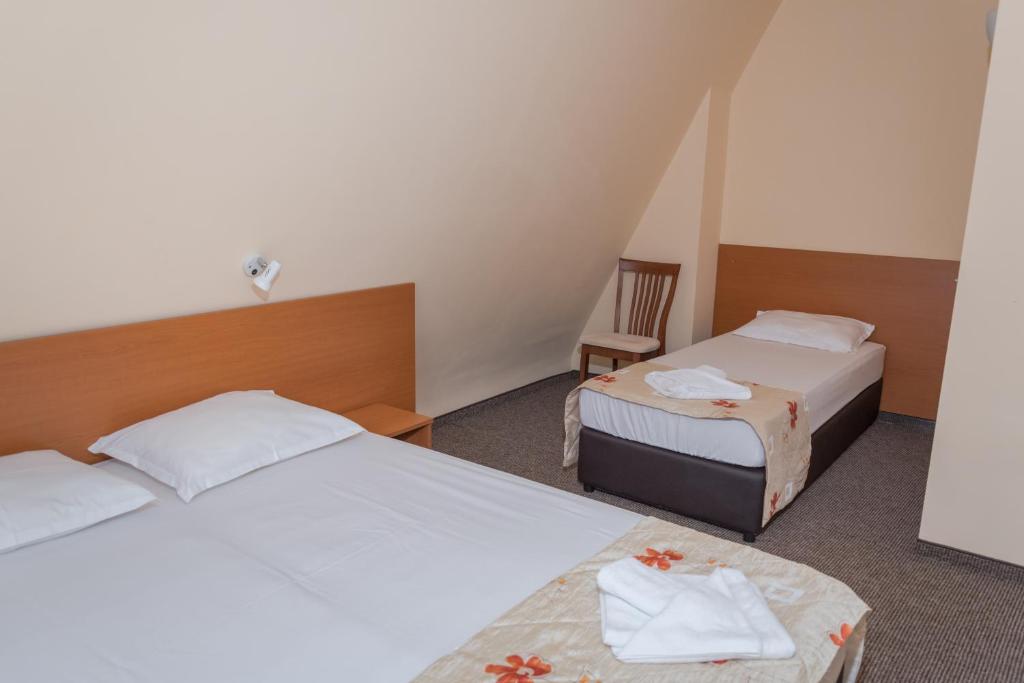 Postel nebo postele na pokoji v ubytování Hotel Eva