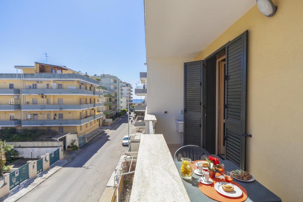 a balcony with a table with food on it at Appartamento Lido Vistamare in Gallipoli