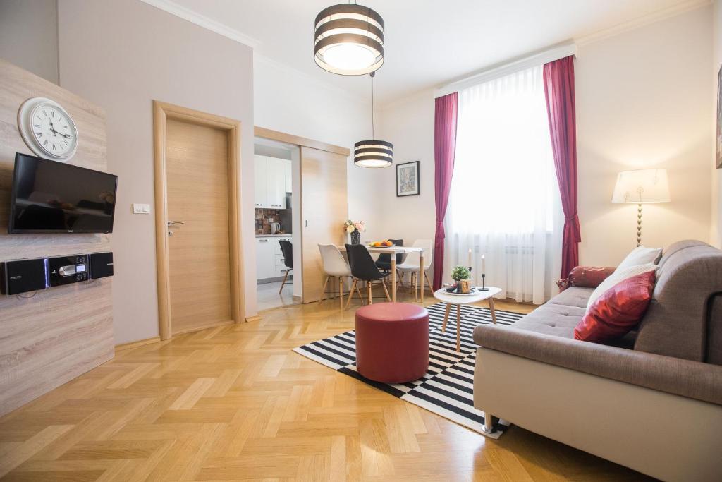 a living room with a couch and a table at Angela Main Street Luxury Oasis & Free parking in Zagreb