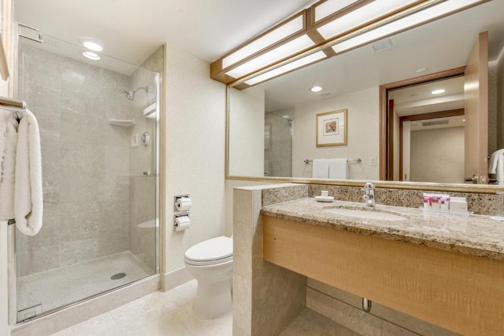 a bathroom with a shower, sink, and toilet at Harrah's Lake Tahoe Hotel & Casino in Stateline