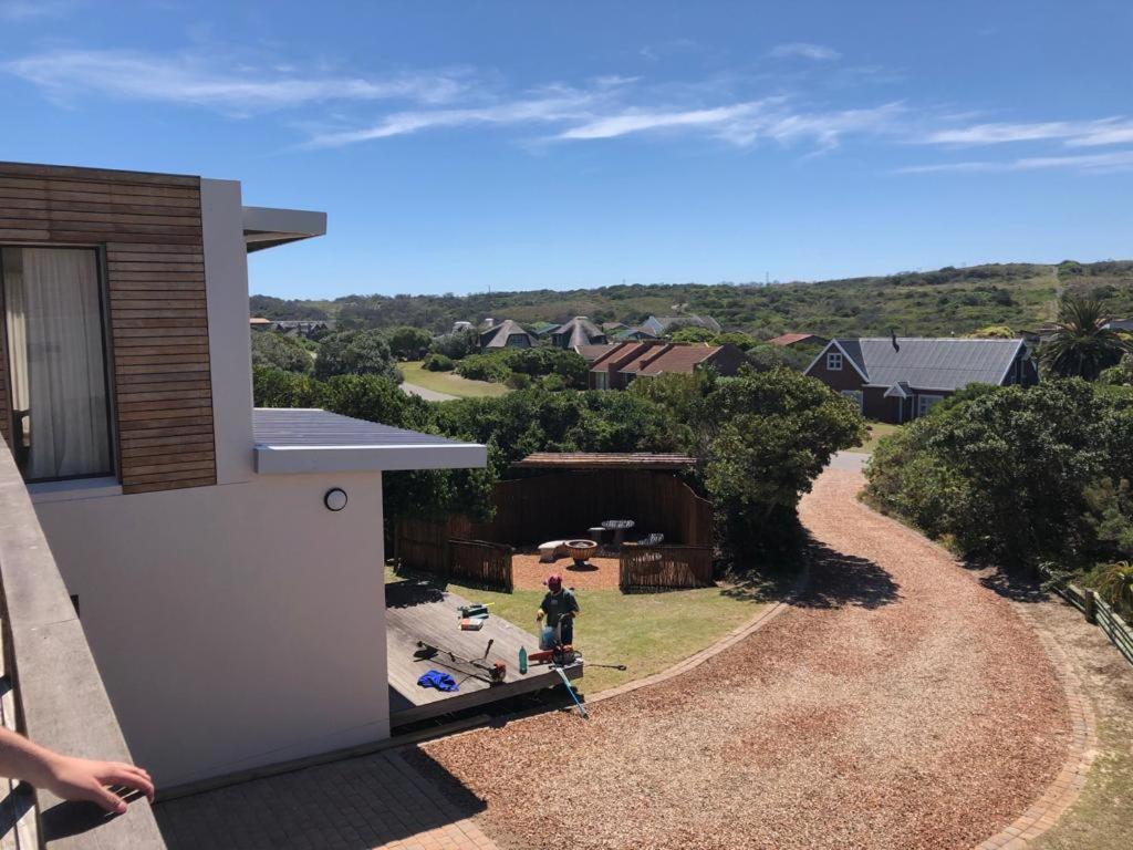 a man standing on the side of a house at 91 Da Gama Beach House in Cape St Francis