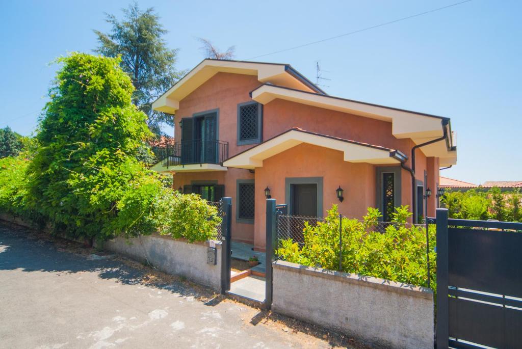 a house with a fence in front of it at B&B La Rena Rossa in Nicolosi