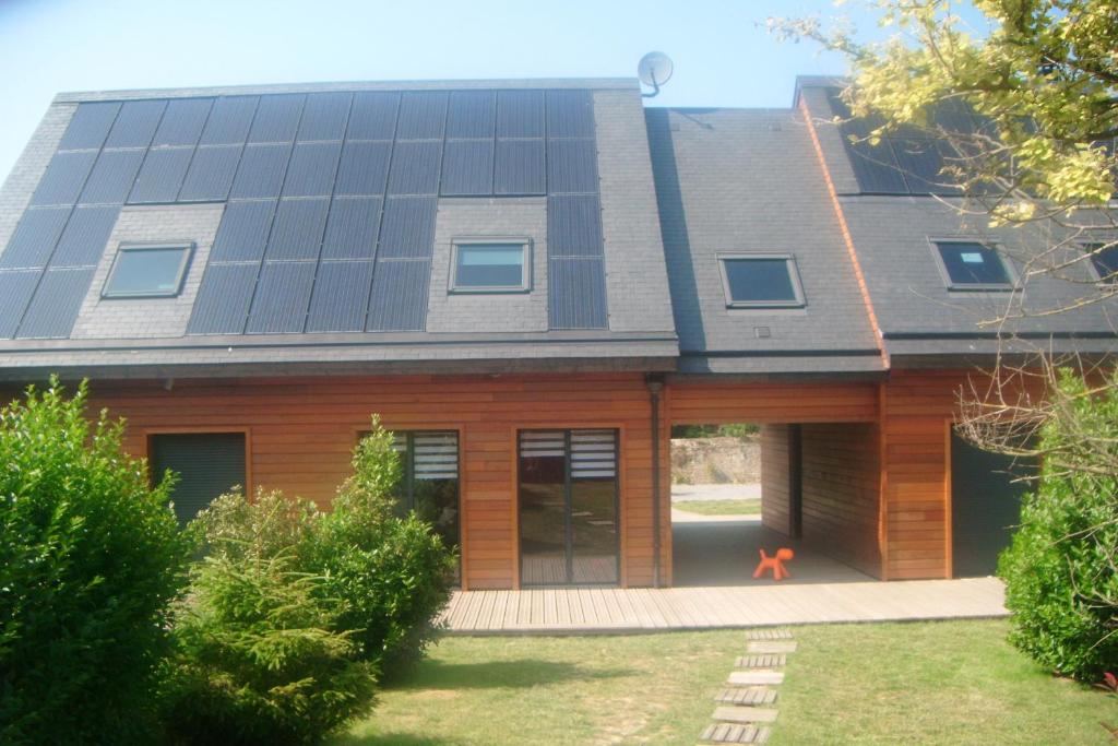 a house with solar panels on the roof at Villa Marylou in Bernières-sur-Mer