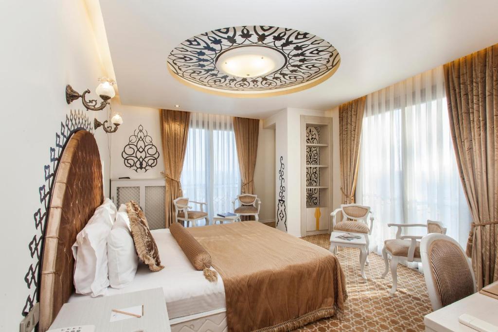 a bedroom with a large bed and a large chandelier at Ottoman Hotel Park - Special Category in Istanbul