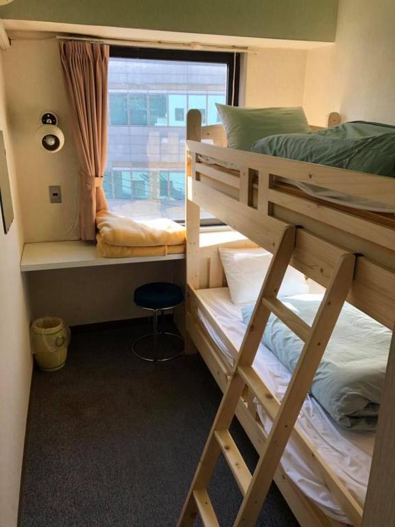 Postel nebo postele na pokoji v ubytování Guest House M104 Kagoshima