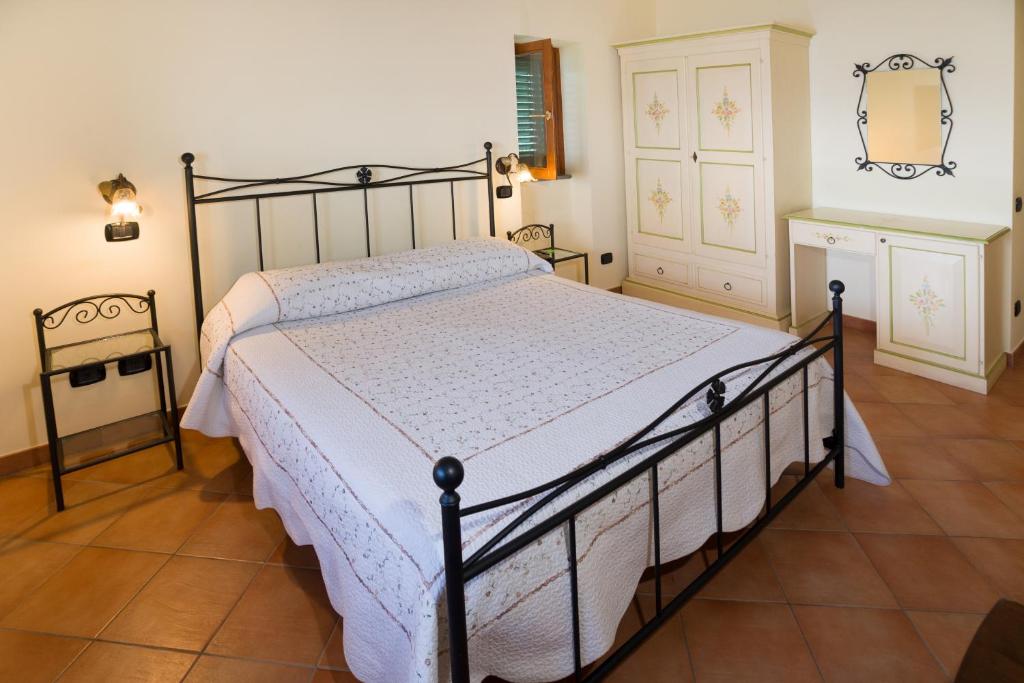 a bedroom with a black bed with a white comforter at Il Glicine in Cetara