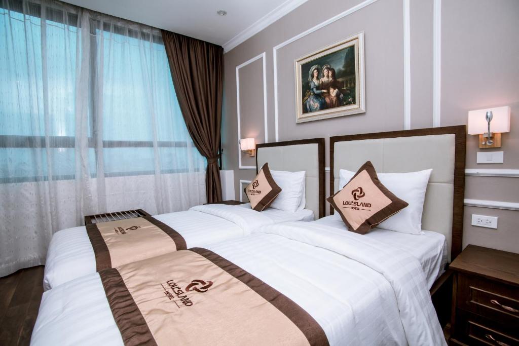 Postel nebo postele na pokoji v ubytování Louisland Hanoi Hotel