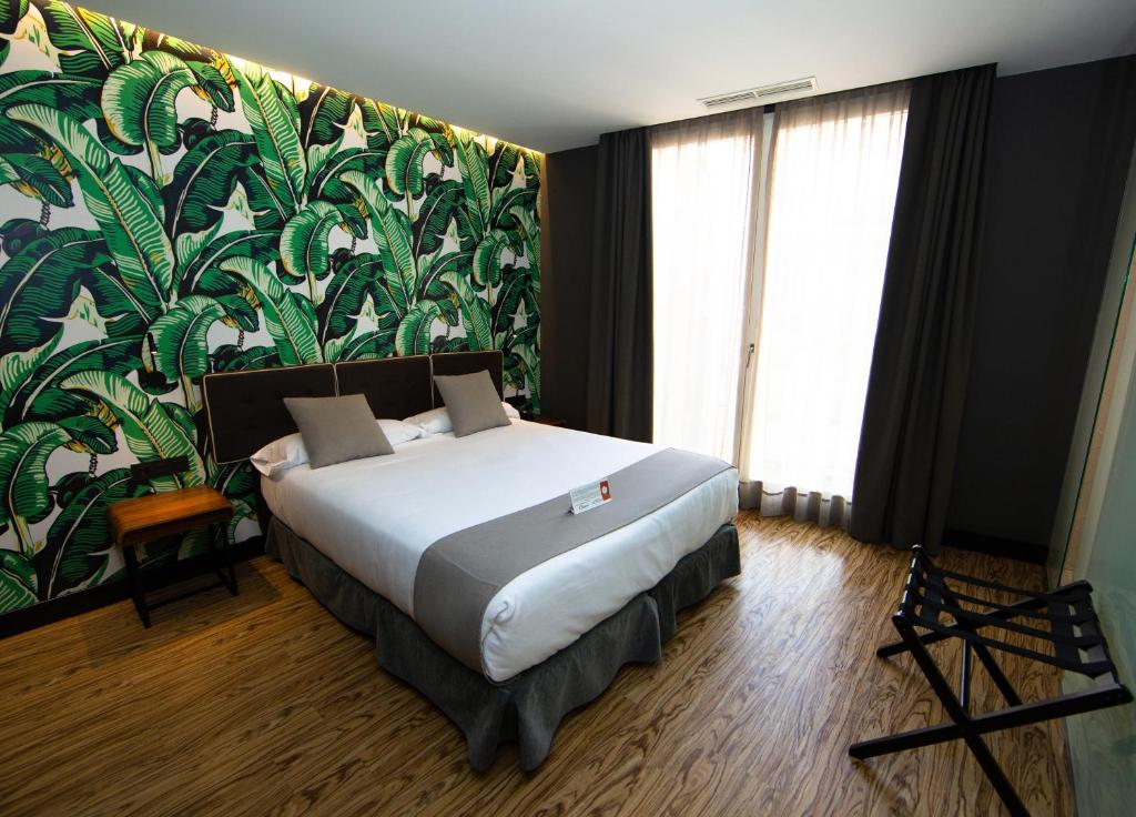 Posteľ alebo postele v izbe v ubytovaní Málaga Premium Hotel