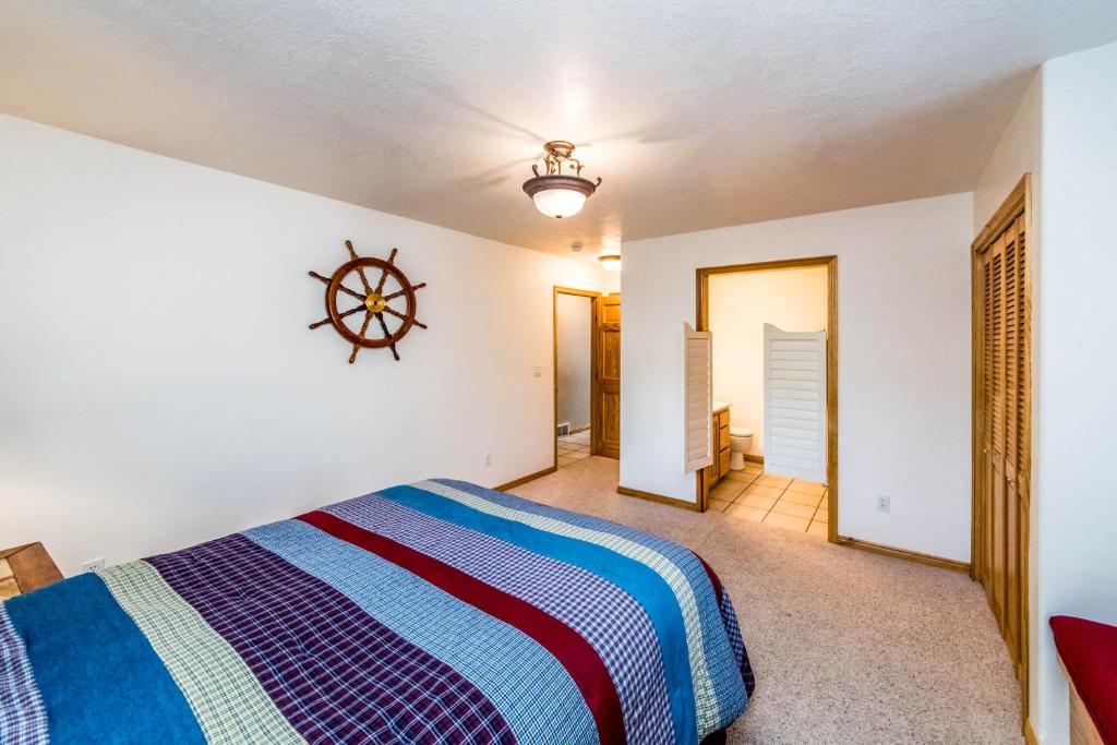 a bedroom with a bed and a wheel on the wall at Bear Lake Vacation Station in Fish Haven