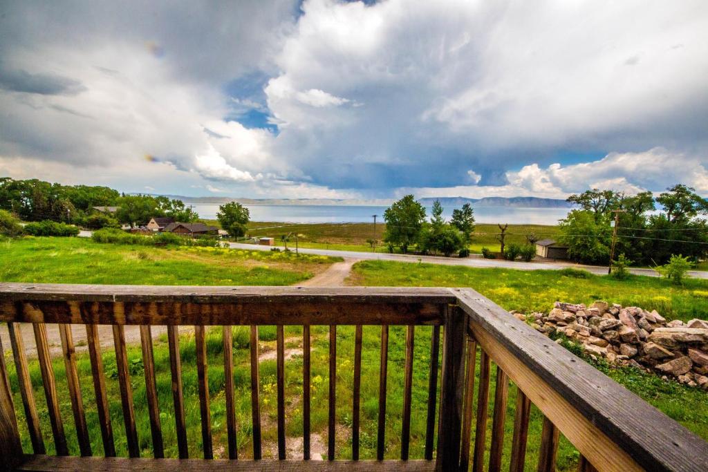 a wooden balcony with a view of a road at Meadow Mountain Home in Garden City