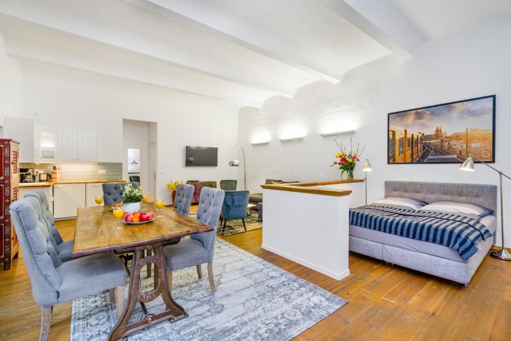 a living room with a bed and a dining room at GreatStay Apartment - Melchiorstr. in Berlin