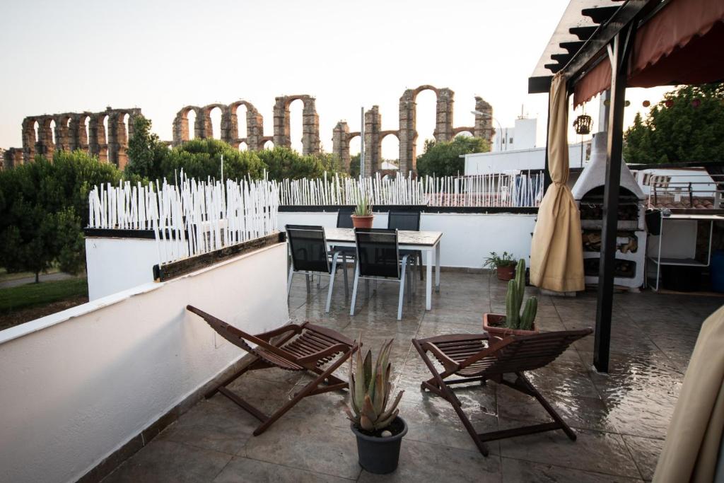 a patio with chairs and a table and a fence at La abuela Pepa Fácil Aparcamiento in Mérida