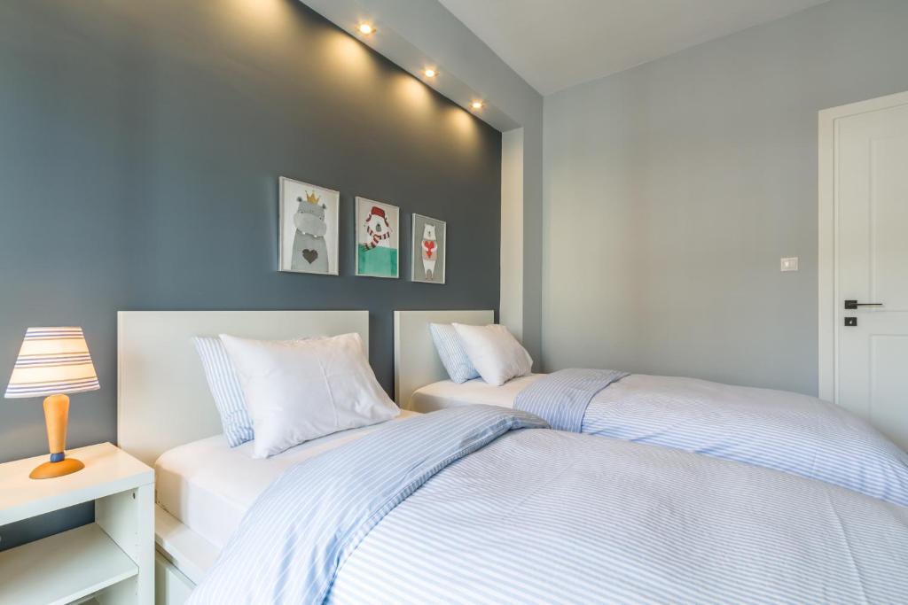 Łóżko lub łóżka w pokoju w obiekcie Nordic Design 5star Apartment
