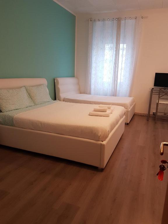 Posteľ alebo postele v izbe v ubytovaní B&B Porto Vecchio ROOMS - Stazione Centrale Trieste