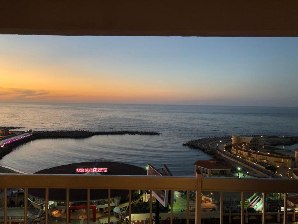 a view of the ocean at sunset from a building at Blue Bay Beach-Families only in Alexandria