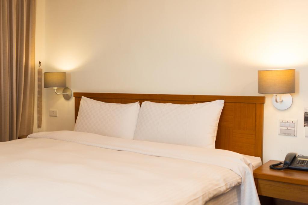Postel nebo postele na pokoji v ubytování Bowa Hotel Penghu