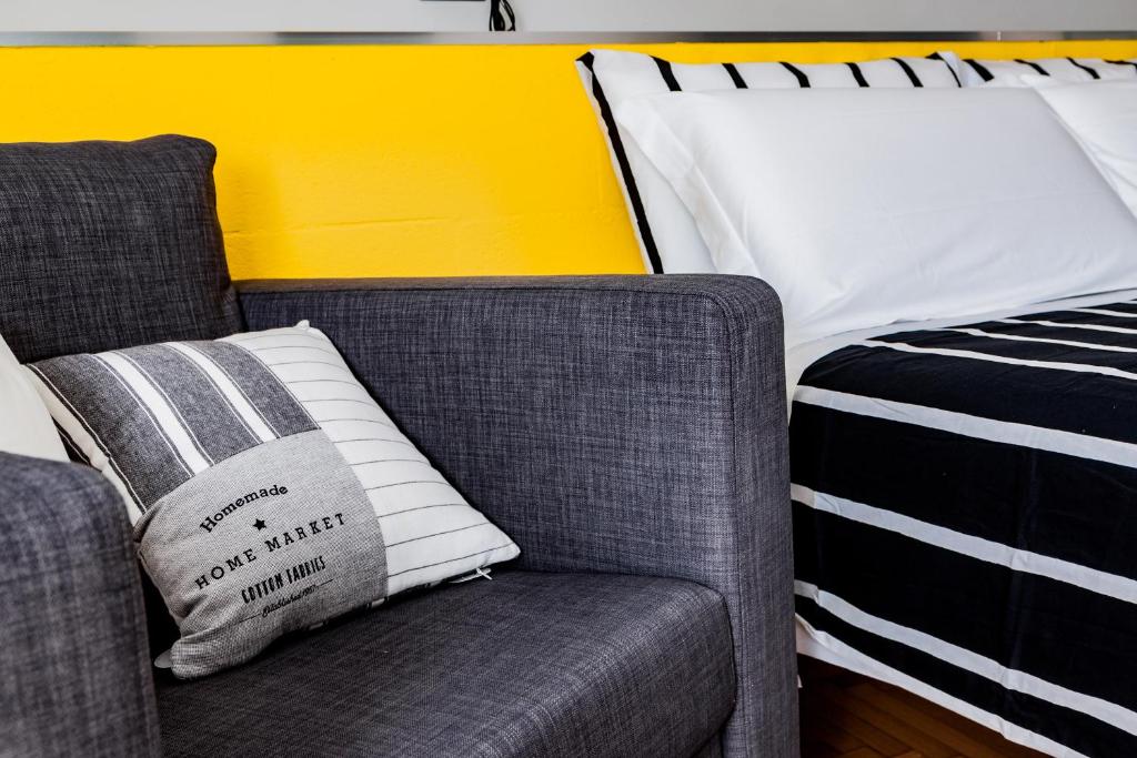 a couch and a pillow next to a bed at TRAVEL STATION Bedandbreakfast in Bari