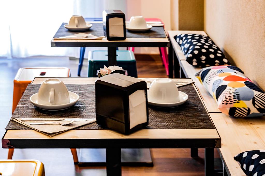 a group of tables with plates and utensils on them at TRAVEL STATION Bedandbreakfast in Bari