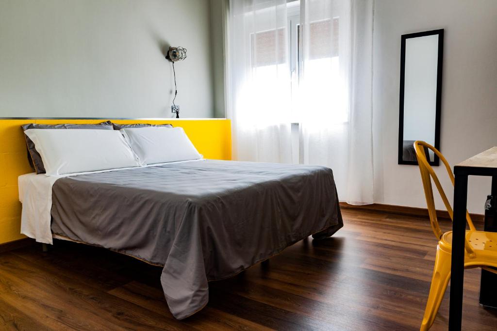 a bedroom with a bed with a yellow wall at TRAVEL STATION Bedandbreakfast in Bari