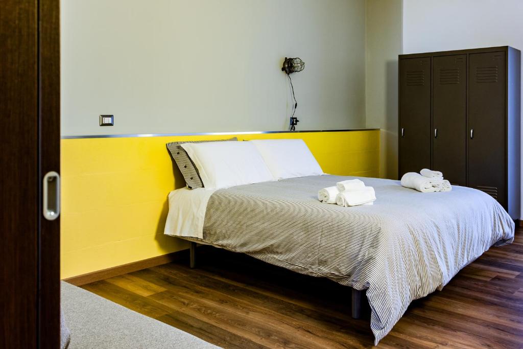 a bedroom with a bed with two towels on it at TRAVEL STATION Bedandbreakfast in Bari