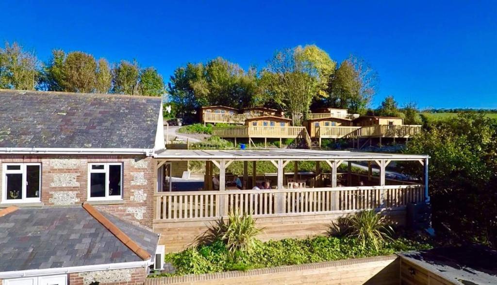 a home with a large deck and a house at The Rivers Arms in Dorchester