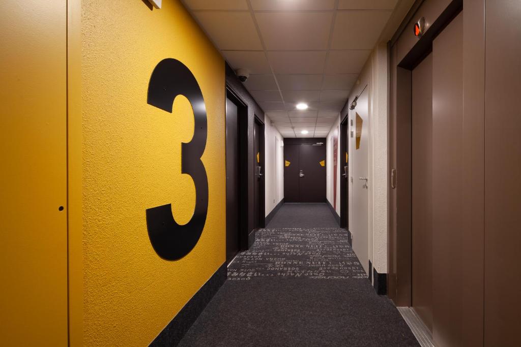 a hallway with a number five painted on the wall at B&B HOTEL Paris Le Bourget in Le Bourget