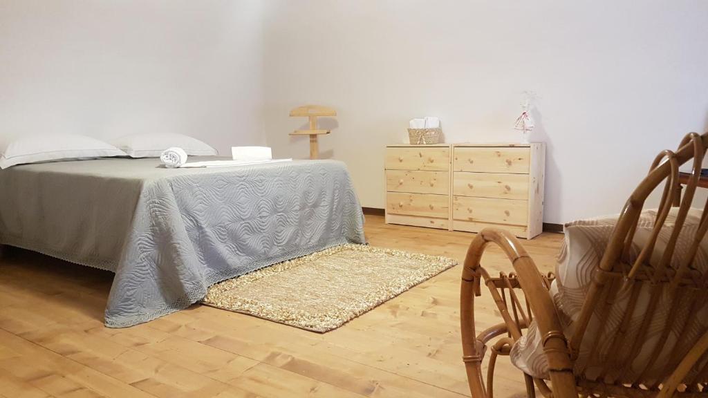 a bedroom with a bed and a dresser and chairs at La Casetta di Rosetta in Bisceglie