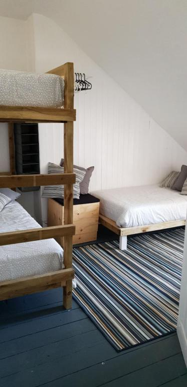 a bedroom with two bunk beds and a rug at Bunkhouse Bournemouth in Bournemouth