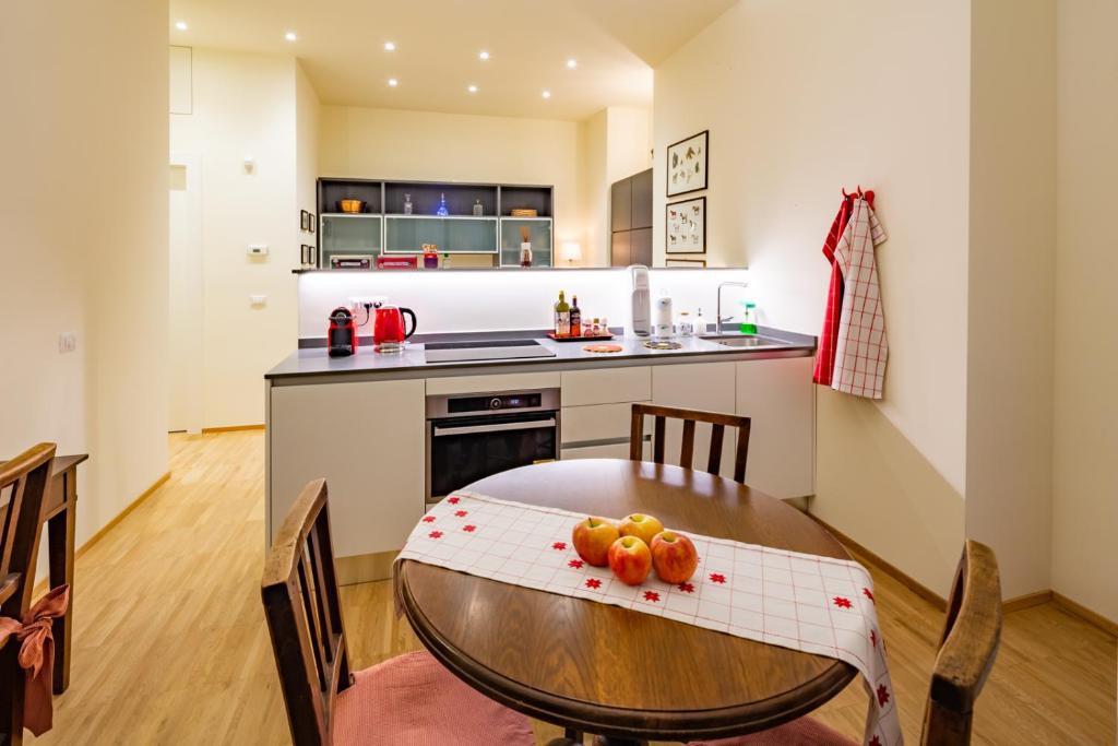 a kitchen with a table with oranges on it at LA CASA COLORATA - Flats in Milan - Bocconi in Milan