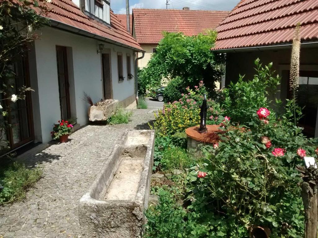 a garden with flowers and a stone pathway at Ferienhaus Herzogenreuth in Heiligenstadt